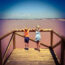 2 children looking out over a pink salt lake