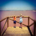 2 children looking out over a pink salt lake